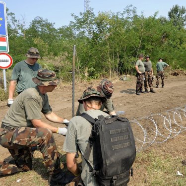 
Members of the Hungarian Defence Force erecting a border fence in 2015 to stem a wave of refugees.