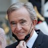 LVMH chief Bernard Arnault, with wife Helene, has been working to make sure his company will stay firmly in his family’s hands.