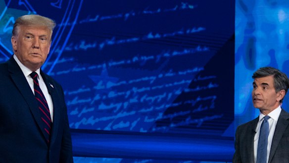 US President Donald Trump talks with ABC News anchor George Stephanopoulos before a town hall at National Constitution Centre in Philadelphia.