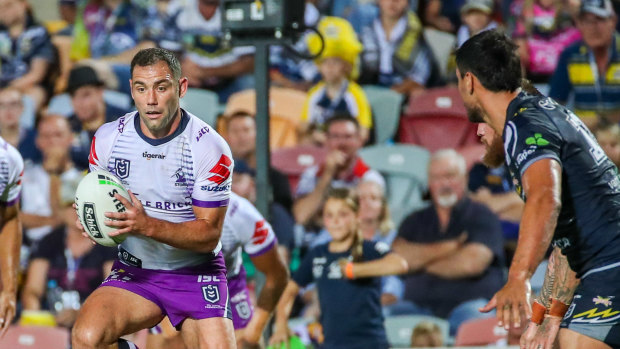 Storms captain Cameron Smith makes his way over Jake Clifford of the Cowboys on Friday.