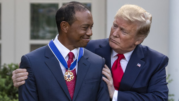 US President Donald Trump embraces Tiger Woods after he won the Masters last year.