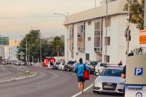 Jackson (Jacko) Doolan, a Tamarama lifeguard, running towards the scene with a first aid backpack and no shoes.