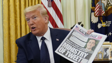 US President Donald Trump with a copy of The New York Post last year.