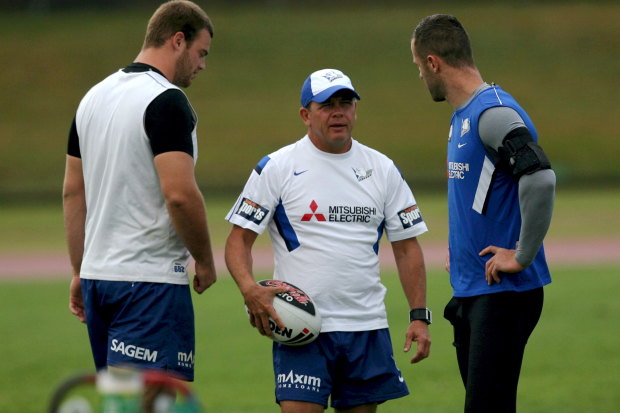 Former Bulldogs coach Kevin Moore (centre) talks to his players at training.