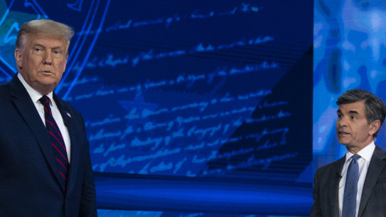 US President Donald Trump talks with ABC News anchor George Stephanopoulos before a town hall at National Constitution Centre in Philadelphia.