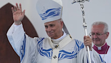Pope Leo XIV waves to faithful after celebrating Mass in Lampedusa, Sicily, on July 4.