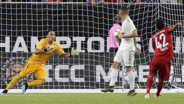 Sarpreet Singh strikes past Real Madrid goalkeeper Keylor Navas, but the goal was ruled out for offside.