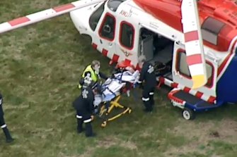 An injured man is loaded onto an air ambulance on Friday afternoon.