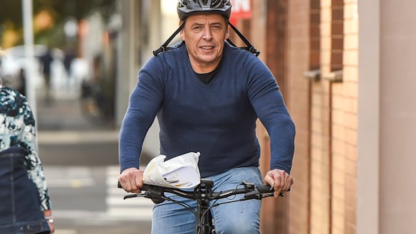 Mark Thompson cycling in Port Melbourne the day after his court appearance.