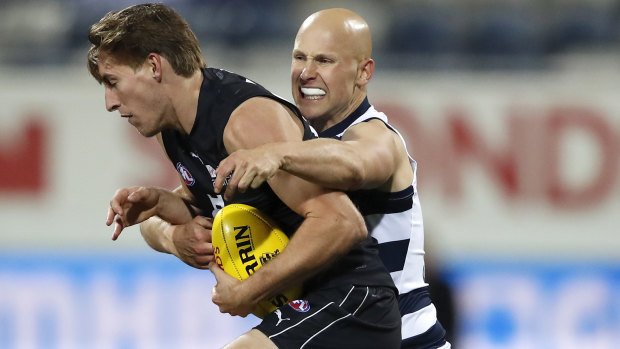 Will Setterfield is tackled by Gary Ablett.