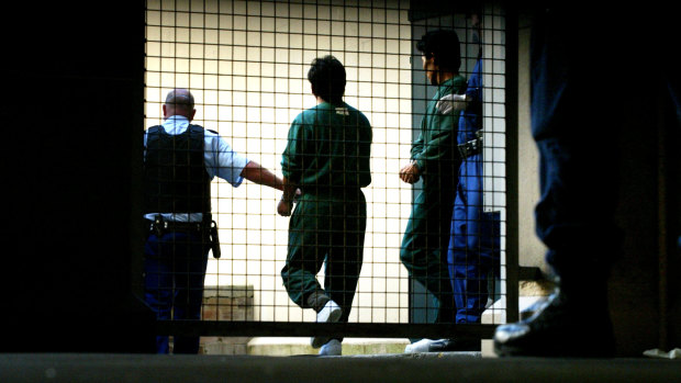 Pong Su crew members being escorted out of Sydney Central Local Court in 2003