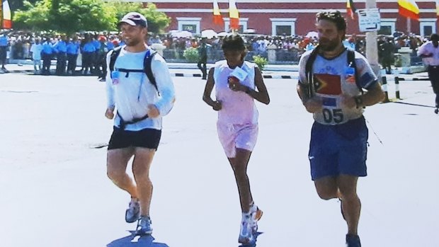 From left, Dan Gosling, Aguida Amaral and Luke Gosling cross the finish line in Dili in 2003.