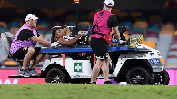 Collingwood's Isaac Quaynor is carried from the field after suffering a lower leg injury against the Swans.
