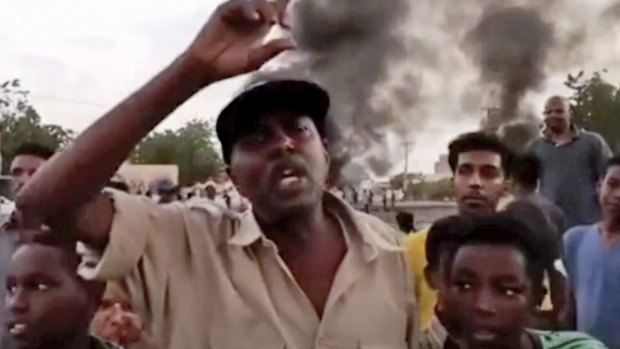 In this frame taken from video people gather during a protest in Khartoum.