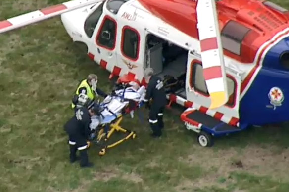 An injured man is loaded onto an air ambulance on Friday afternoon.