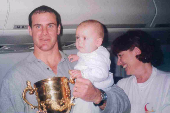 Former Wallabies vice-captain David Wilson, with the Webb Ellis Cup and the unknown baby.