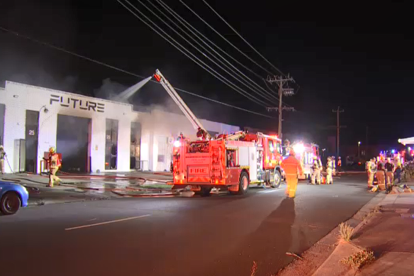 Firefighters at the scene of a deliberately lit factory fire at Clayton South.