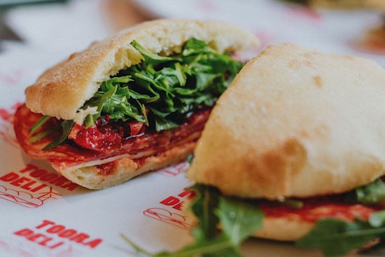 A house-baked puccia with hot salami, provolone, semi-dried tomatoes, rocket and chilli at Tooradeli.