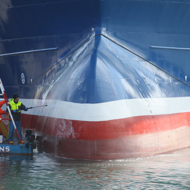 Workers clean Lunar Bow, one of the largest trawlers in Peterhead harbour.