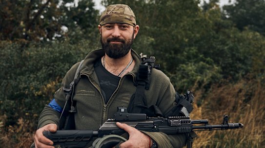 A Ukrainian soldier smiles in the freed territory in the Kharkiv region, Ukraine.