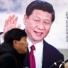People walk past a propaganda billboard showing Chinese President Xi Jinping along a street in Beijing, Friday, March 2, 2018. The annual meetings of China's top legislative bodies are set to begin on Saturday, during which the two-term limit on China's presidency is expected to be removed. (AP Photo/Mark Schiefelbein)