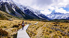 Hike the Hooker Valley Track. This incredible three-hour return walk offers some of the highest reward-to-effort ratios of any hike in the country - no mountaineering expertise needed. The flat, well-maintained trail leads you across three spectacular swing bridges and through an alpine valley flanked by the Southern Alps. It ends at a glacial lake sitting directly beneath the towering, snow-capped peak of Aoraki (Mount Cook).