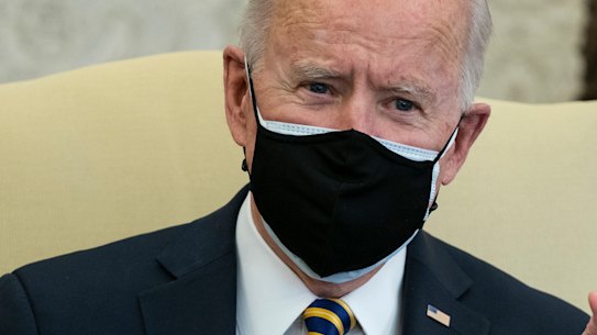 US President Joe Biden holds up a microchip during a meeting with lawmakers to discuss US supply chains.