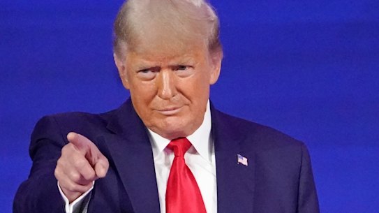 Former president Donald Trump points to cheering supporters in Florida.