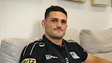Nathan Cleary accepts his award on the couch. 