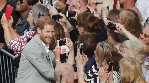 Prince Harry greets crowds in Windsor on Friday.