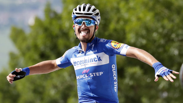 New overall leader: France's Julian Alaphilippe celebrates as he crosses the finish line to win the third stage of the Tour de France.