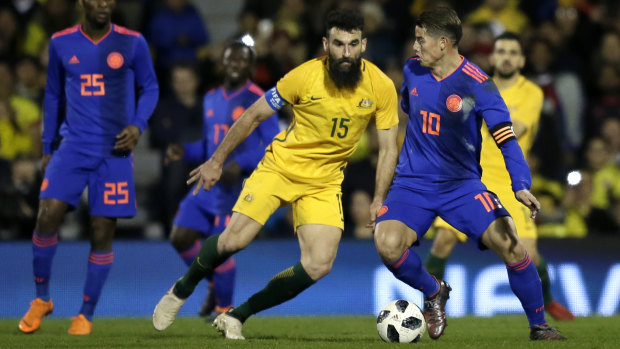 Colombia's James Rodriguez duels with Australia's Mile Jedinak.