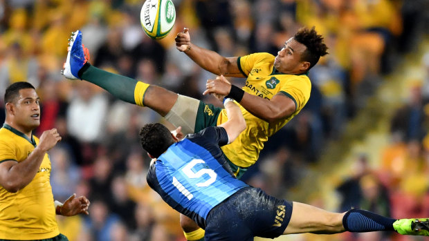 Will Genia of the Wallabies flies for the ball over Joaquin Tuculet. 