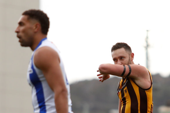 Hawthorn’s Jack Gunston, who recently lost his father Ray, kisses his black armbands after a goal against North.