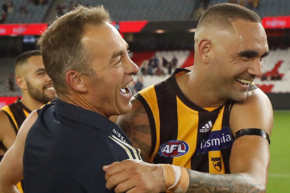 Hawks coach Alastair Clarkson, left, celebrates after his side beat the Bombers on Saturday. 