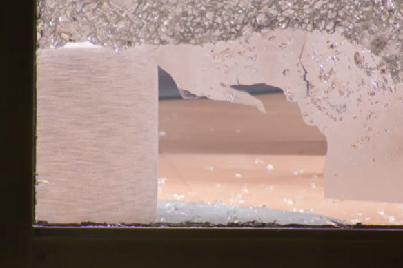 The hole that was smashed to enter the shop.