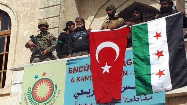 Turkish and Turkey-backed Free Syrian Army soldiers in the centre of Afrin on Sunday.