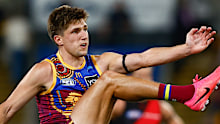 Zac Bailey of the Lions kicks a goal.