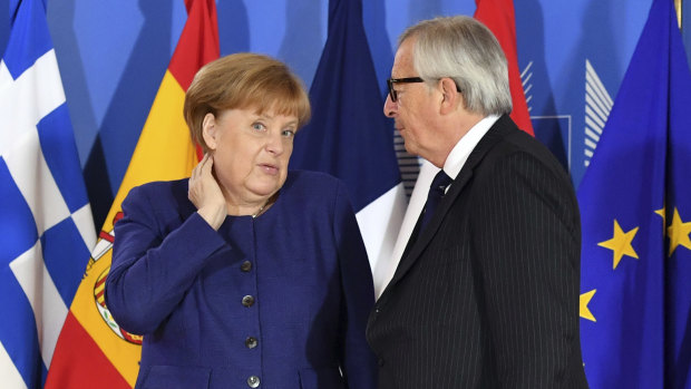 German Chancellor Angela Merkel speaks with European Commission President Jean-Claude Juncker during the informal EU summit on migration in Brussels.
