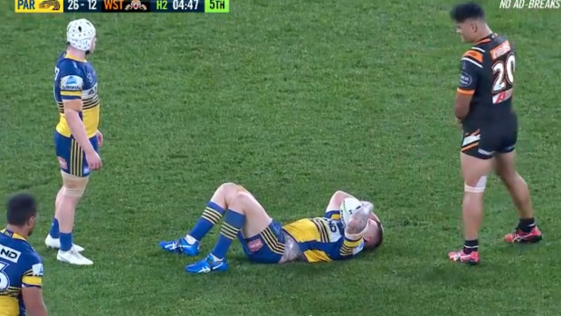 Nathan Brown lies on the ground during Parramatta's clash with the Wests Tigers.
