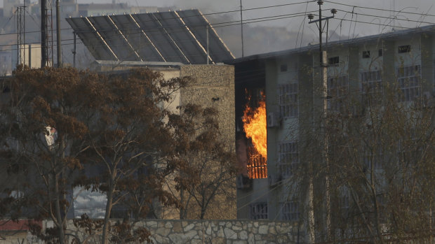 Flames rise from a government building after an explosion and attack by gunmen.