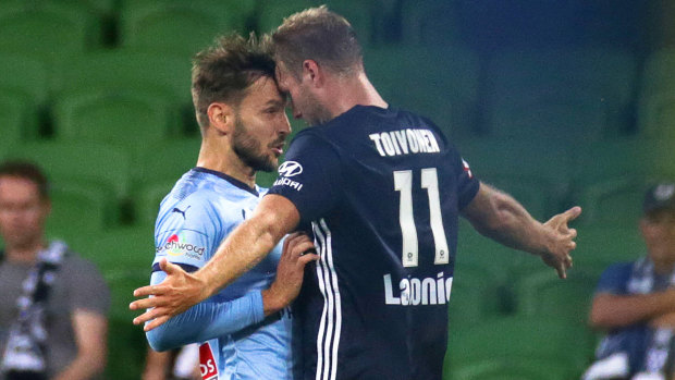 Plenty of feeling: Victory's Ola Toivonen and Milos Ninkovic of Sydney FC clash during the round 16 Big Blue.