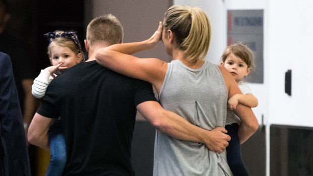 David Warner and his family leave Sydney Airport on Thursday night.