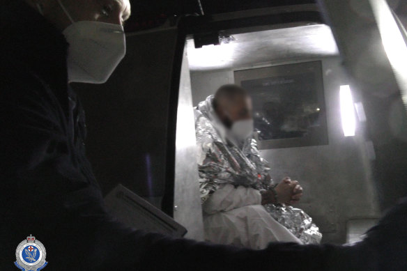 Two of the men under police guard after their arrest.