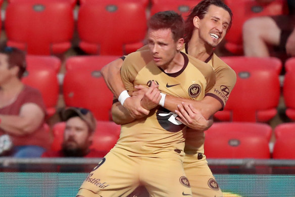 Daniel Georgievski and Nicolai Muller celebrate one of the latter's two goals on Friday night.