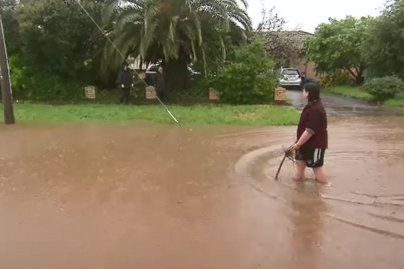 A resident walks through floodwaters in Seymour on October 13.