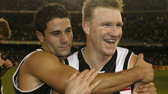 Paul Licuria and Nathan Buckley after a win in 2002.