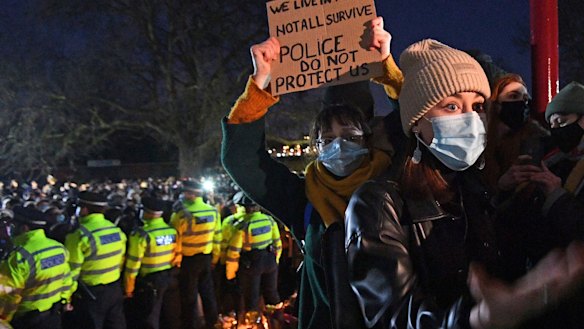 A woman reacts in Clapham Common, as people gather despite the Reclaim These Streets vigil for Sarah Everard being officially cancelled, in London.