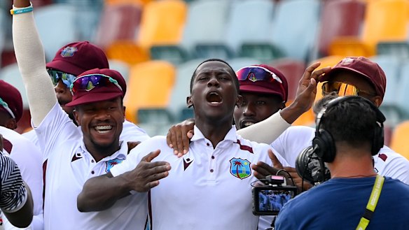 Shamar Joseph celebrates with teammates at the Gabba.
