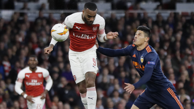 Arsenal's Alexandre Lacazette heads the ball to score their second goal against Valencia.